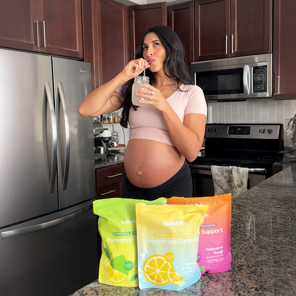 Pregnant mom sipping babybub through a straw